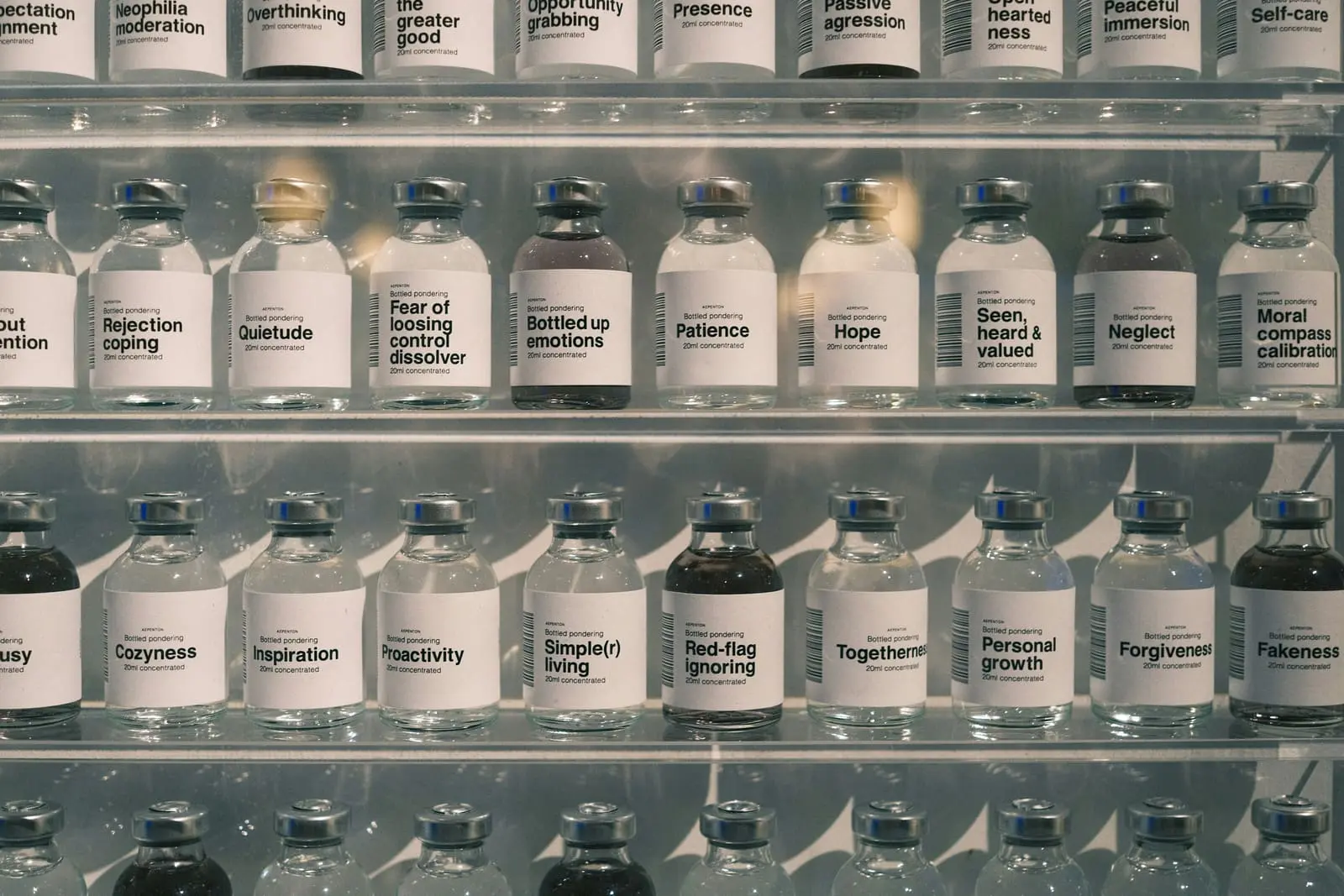 Many glass bottles lined up on shelves.